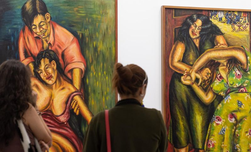Mujeres viendo una exposición de cuadros femeninos