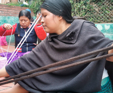 mujer indígena tejiendo